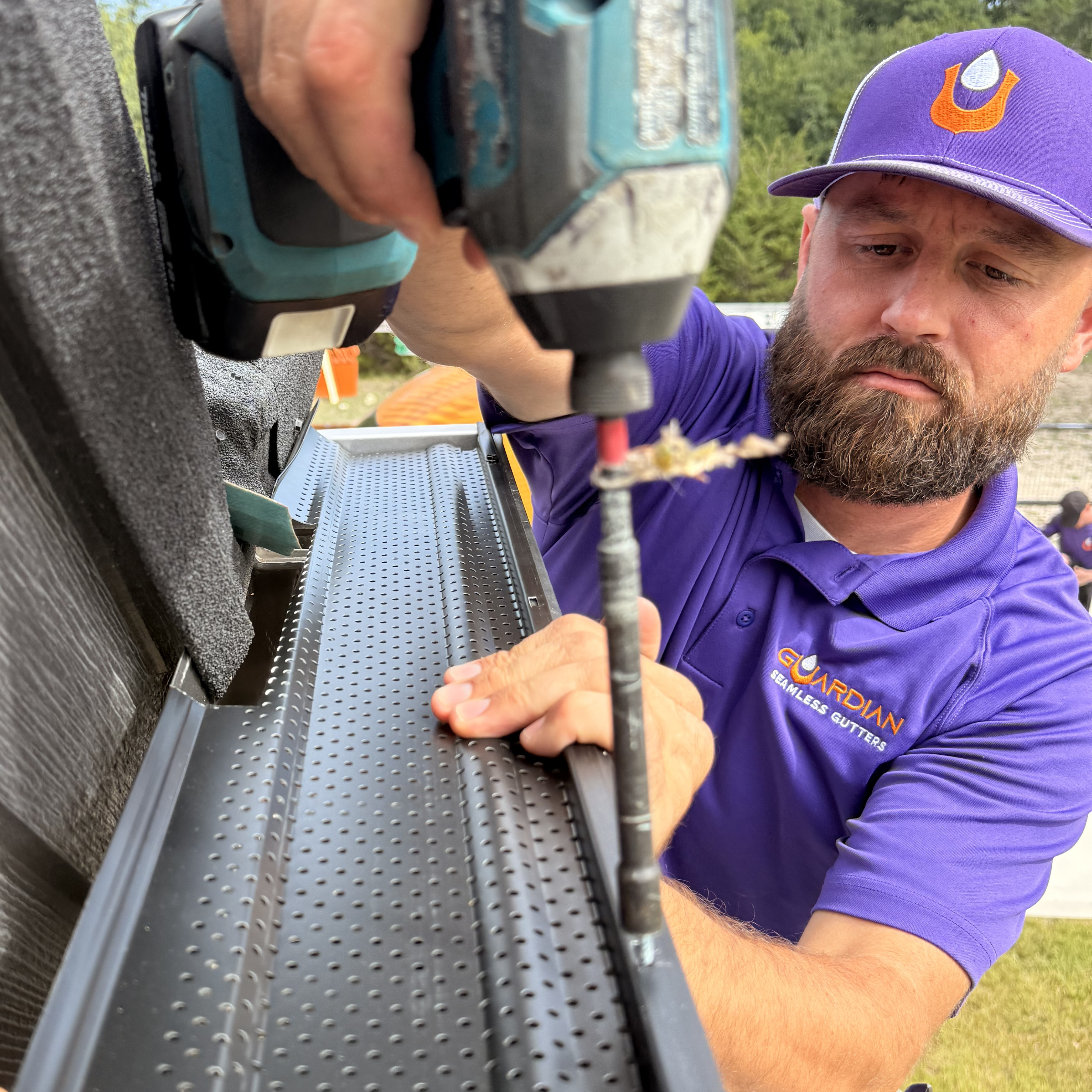 Professional seamless gutter installation on a North Texas home